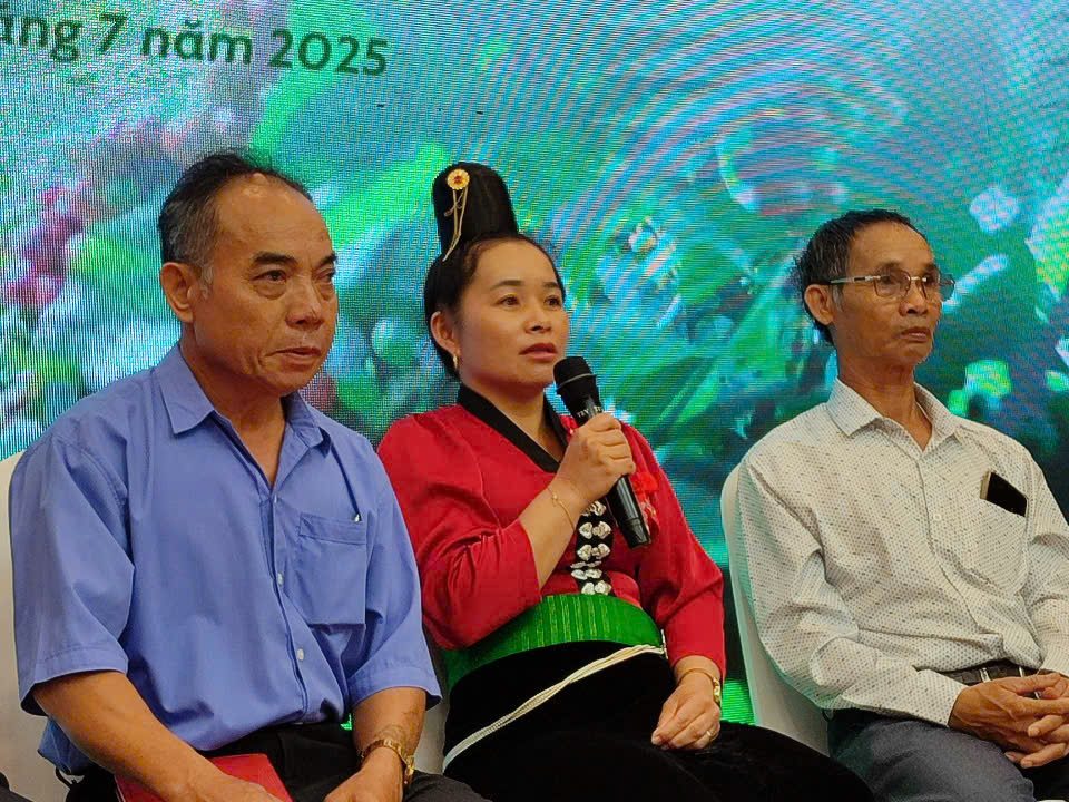 A discussion panel at a coffee sector technical exchange event in Buôn Ma Thuột, Vietnam, featuring three speakers, including a woman in traditional attire, discussing EU deforestation regulations.