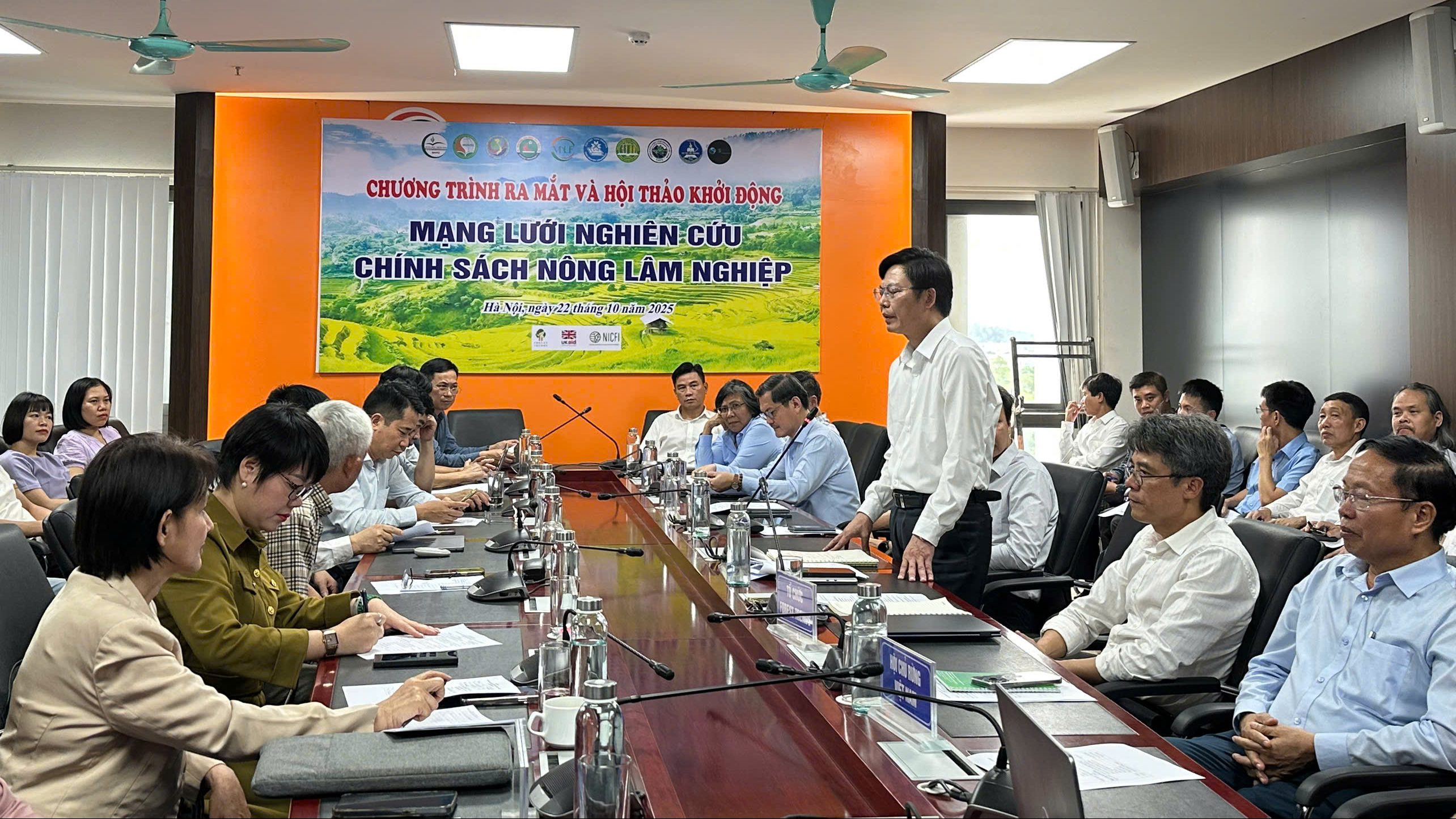 A meeting at Vietnam National University of Forestry featuring multiple participants discussing the launch of the Agricultural and Forestry Policy Research Network.